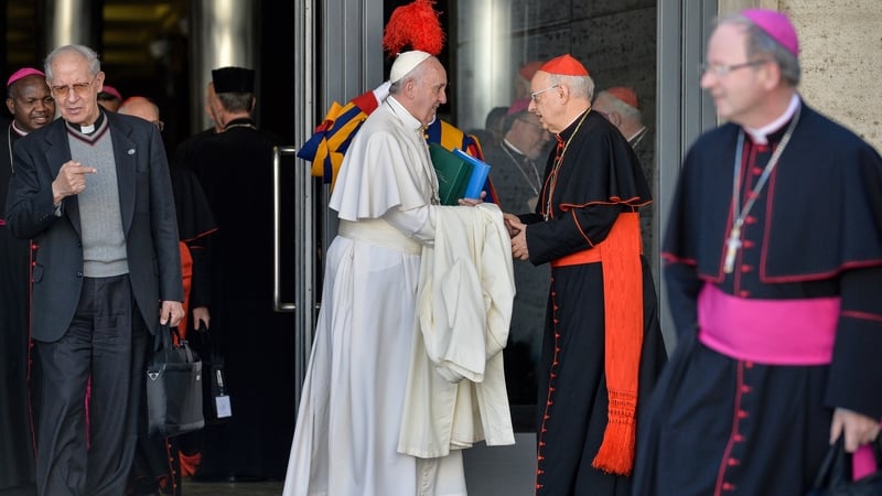 Pope Francis shakes hands with Italian cardinal Lorenzo Baldisseri as he leaves the morning session of the last day of the Synod