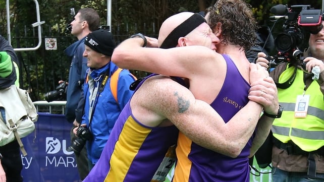 Good job - runners embrace at the finish line