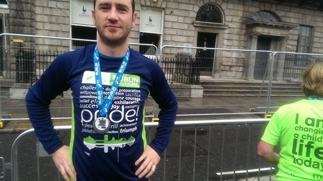 A satisfied runner poses for a photo at the end of the race