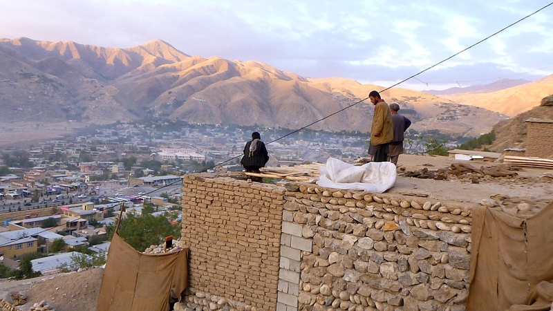 Afghan householders gather on the roof of a house Faizabad in Badakhshan Province