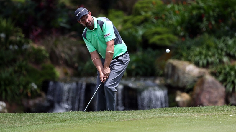 Padraig Harrington chips from just off the green on the 12th hole at Kuala Lumpur Golf & Country Club