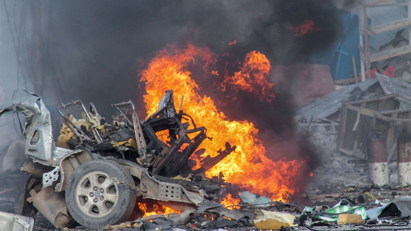 A vehicle burns after a car bomb exploded in front of the Sahafi Hotel in Mogadishu