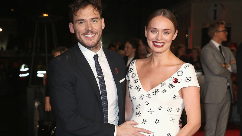 Sam Claflin and Laura Haddock revealed their baby news on The Hunger Games red carpet