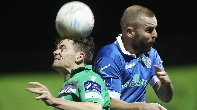Damien McNulty and Lee Lynch battle for possession