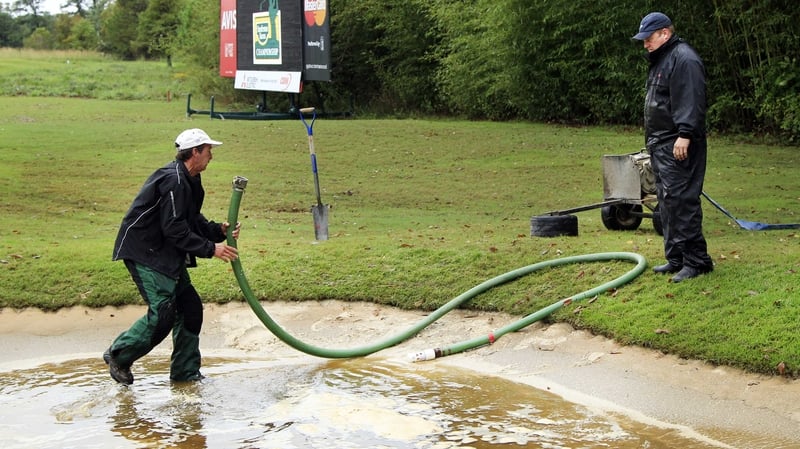 Grounds crews drain the bunkers after heavy rains at the Country Club of Jackson