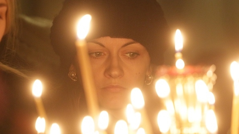 A woman attends memorial service in the memory of Russian airplane crash victims