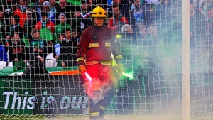 A flare is removed from the ground during the men's final