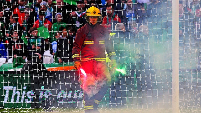 A flare is removed from the ground during the men's final