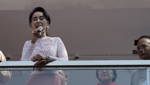 Aung San Suu Kyi delivers a speech from the balcony of the NLD headquarters in Yangon