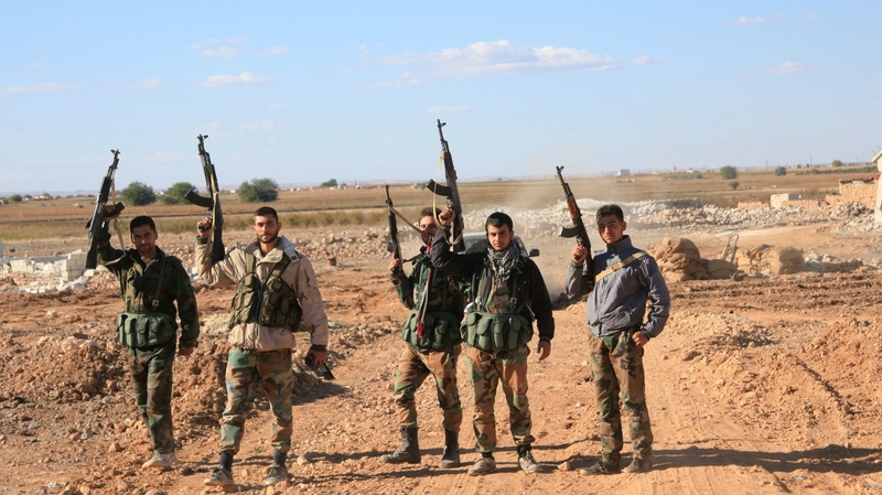 Syrian government troops celebrate after freeing soldiers from airbase siege