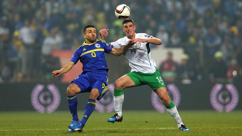 Ciaran Clark challenges Vedad Ibisevic in the 1-1 draw in Zenica