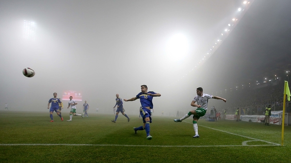 Ireland's Robbie Brady clears as a thick fog covers the pitch