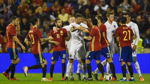 English and Spanish players clash during a flash-point in their friendly game