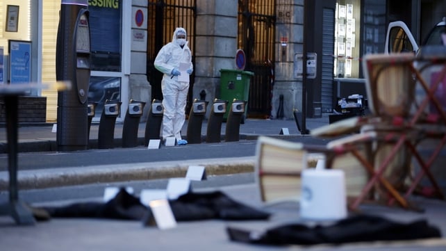 A forensic scientist inspects outside of the Cafe Bonne Biere