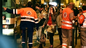 Medics evacuate people close to the Bataclan theatre