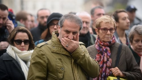 Parisians stand in shocked silence near the scene of one of last night's attacks