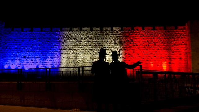 Two men stand in front of Jerusalem's Old City walls