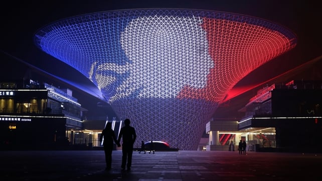 A building on the axis of 2010 Shanghai World Expo is seen lit up for the Paris terror attack victims in Shanghai, China