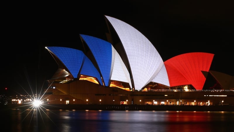 The sails of the Sydney Opera House are lit up in the colours of the French Flag in solidarity with the French people