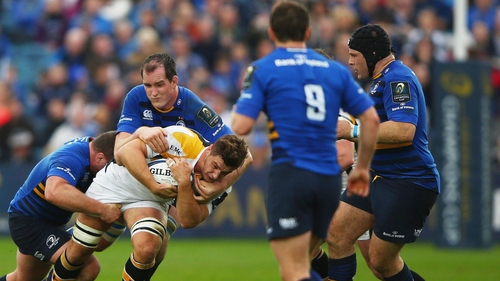 Sam Jones of Wasps is tackled by Devin Toner
