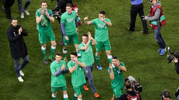 Robbie Keane celebrates with other members of the Ireland squad after securing qualification to Euro 2016