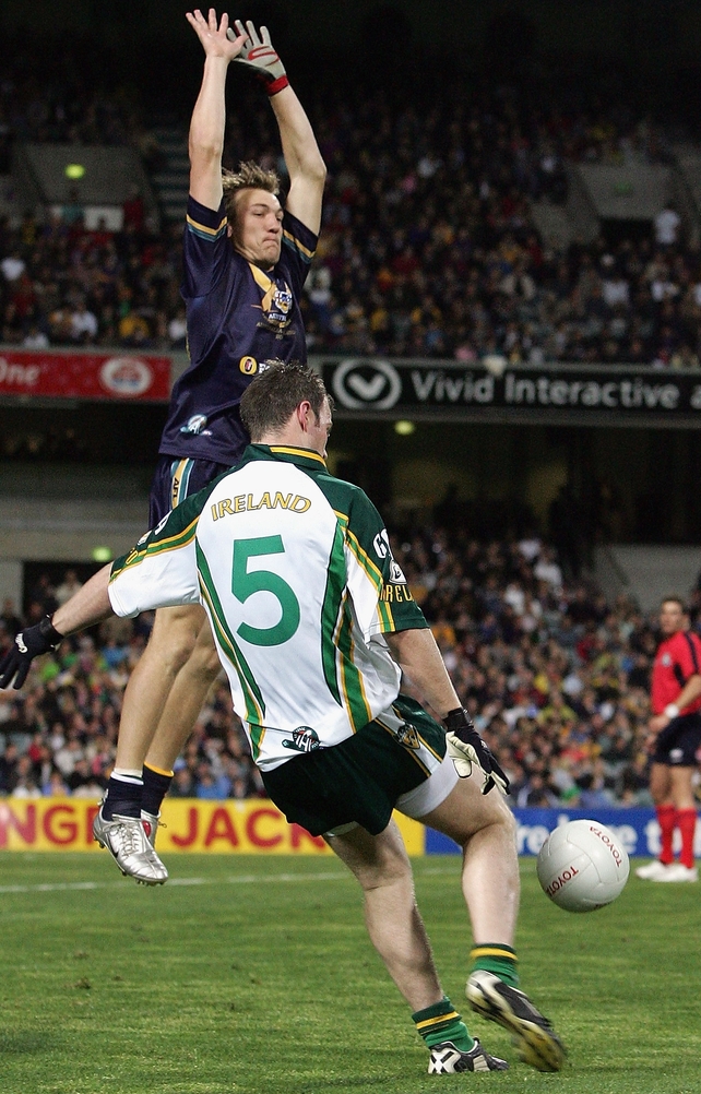 Darren Milburn of Australia attempts to block the kick of Ronan Clarke in 2005