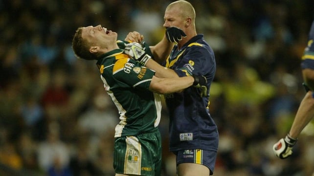 Cormac McAnallen on the end of some rough treatment from Barry Hall of Australia during the 2003 series. The trophy was named after the Tyrone star after his death in 2004