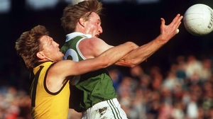 Pat Spillane tries to catch the ball under pressure from an Aussie defender