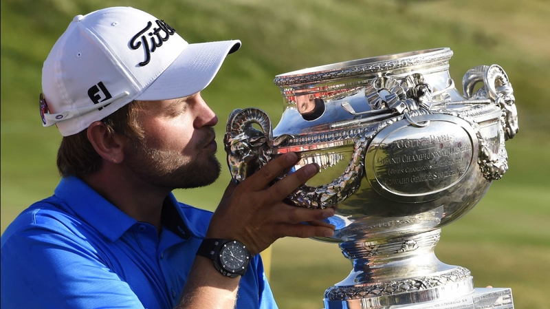 Austria's Bernd Wiesberger holds up his trophy after winning the 2015 Alstom Open de France at Le Golf National in Guyancourt