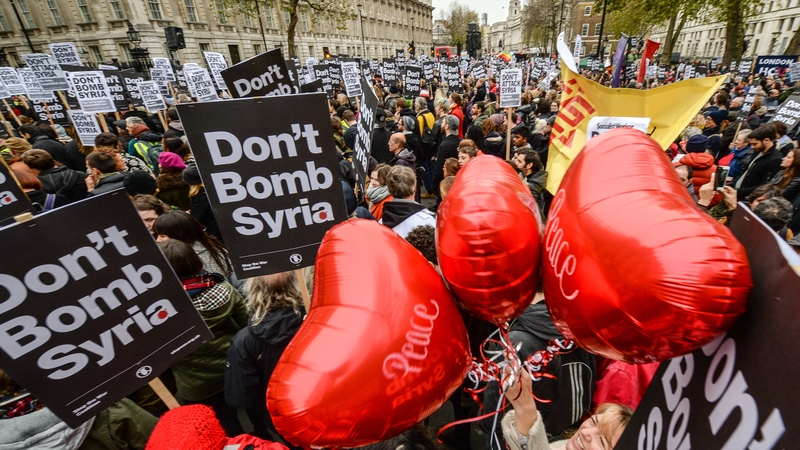 'Peace' balloons float up amongst 'Don't bomb Syria signs' outside Downing Street