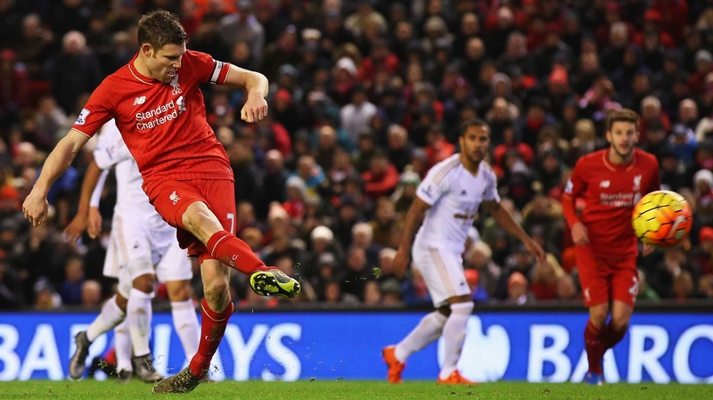 James Milner lifts his penalty high into the Swansea net to put Liverpool ahead