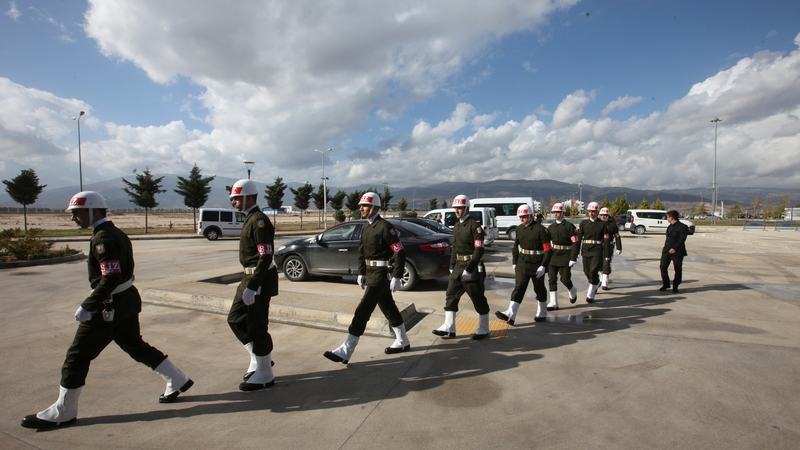Members of a Turkish honour guard arrive for the ceremony at Hatay Airport in Turkey