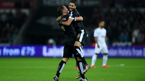 Riyad Mahrez celebrates after scoring his first goal with Danny Drinkwater (L)