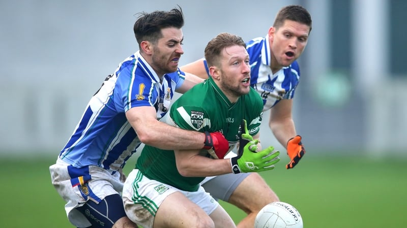 Ballyboden St Enda's Michael Darragh Macauley and Conal Keaney tackle Cahir Healy of Poraloise