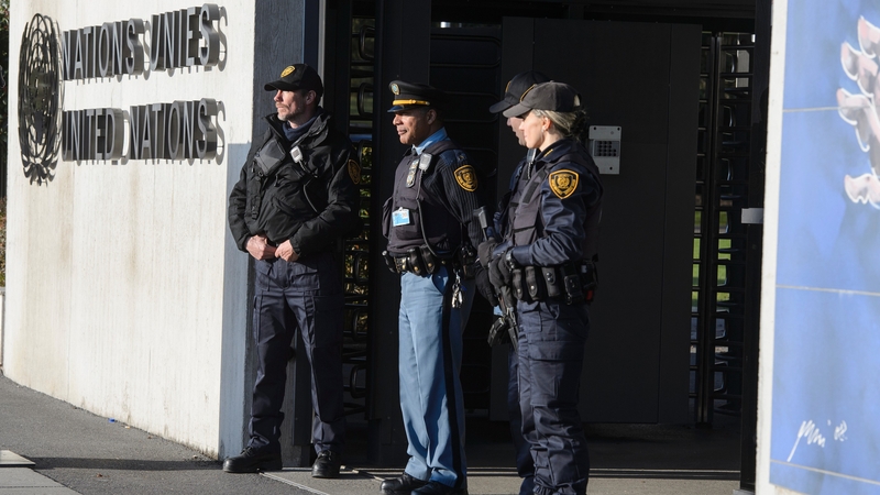 Security forces stand guard at the entrance of the United Nations headquarters in Geneva