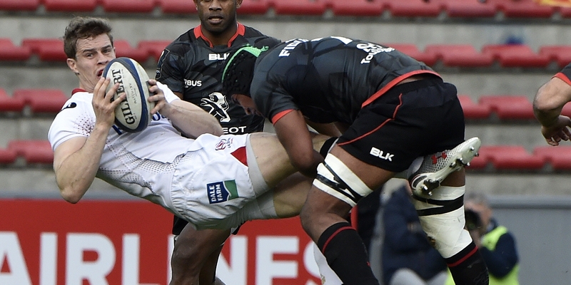 Ulster's Andrew Trimble is upended by Thierry Dussautoir of Toulouse during their side's European Champions Cup meeting in France