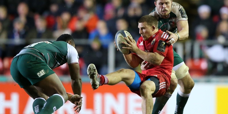 Andrew Conway of Munster is tackled by Leicester Tigers' Ed Slater