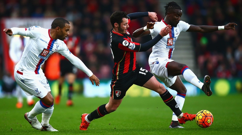 Adam Smith of Bournemouth challenges Pape Souare of Crystal Palace