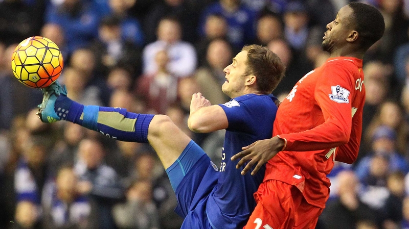 Andy King holds off Liverpool striker Divock Origi