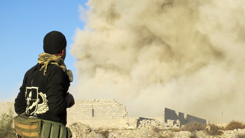 An Iraqi figher watches smoke rising in Ramadi