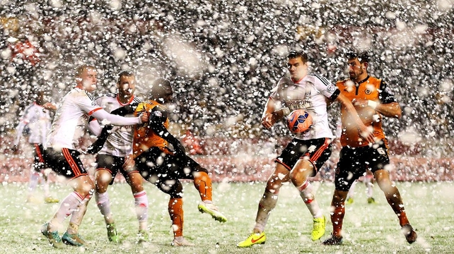 Snow falls during the FA Cup
third round replay between Wolves and Fulham at Molineux