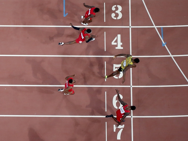 Usain Bolt of Jamaica (R) wins the Men's 100 metres final at the World Championships in Beijing