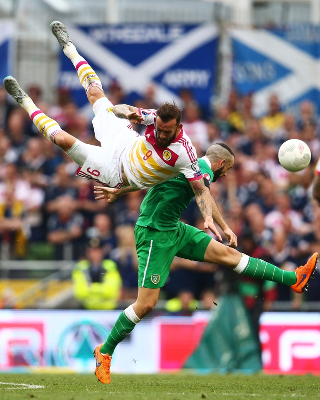 Republic of Ireland defender Marc Wilson beats Steven Fletcher of Scotland in the air