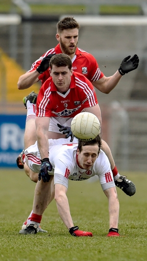 Cork's Eoin Cadogan and Fintan Goold (C) tackle Colm Cavanagh of
Tyrone during the Allianz Football League