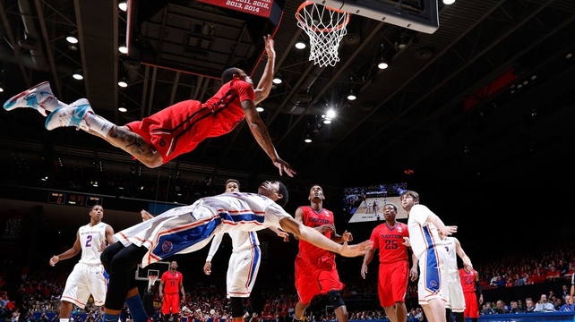 Kyle Davis of the Dayton Flyers goes to the basket against Chandler Hutchison of the Boise State Broncos