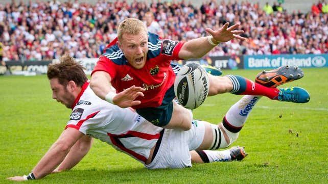 Ulster's Iain Henderson and Keith Earls of Munster compete for the ball