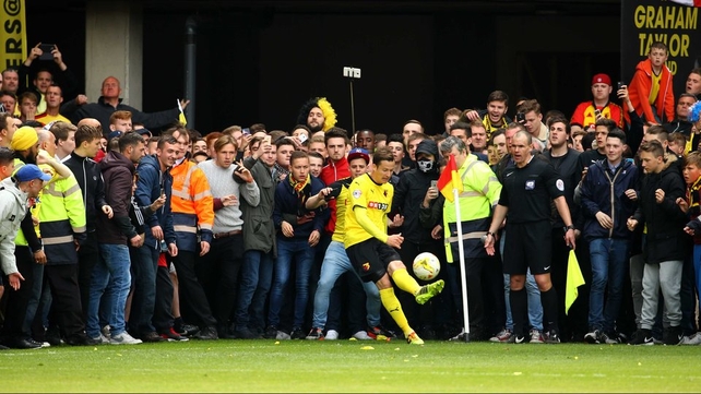 Watford's Daniel Tozser takes a last-minute corner at Vicarage Road as fans wait to invade the pitch as the Hornets secure promotion to the Premier League