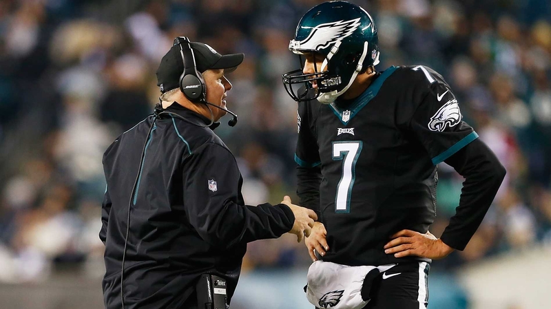 Chip Kelly (L) gives instructions to quarterback Sam Bradford
