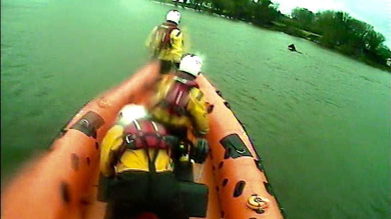 After using the lifeboat to encourage the horse to swim towards shore, the crew waded in to the water to discourage the horse from swimming back out into the lake