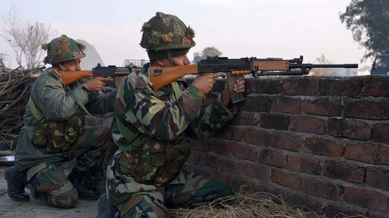 Indian army soldiers take up position on the perimeter of the base